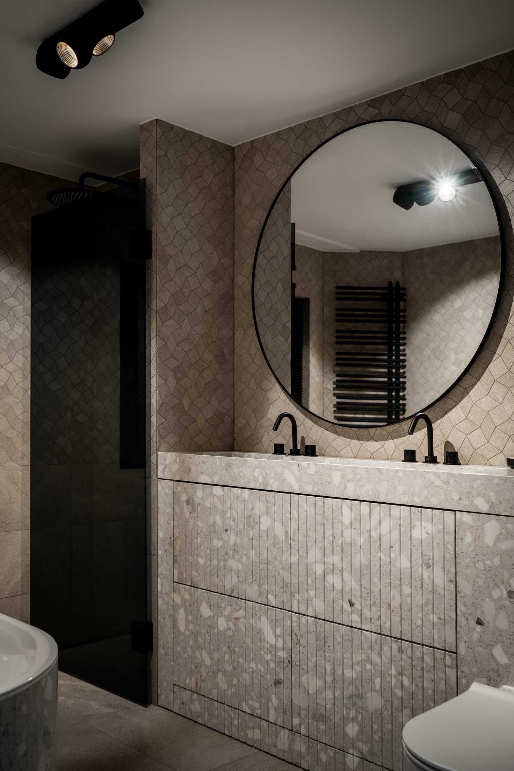 Tall view of the Riverslate vanity, round mirror and ceiling spots in the bathroom